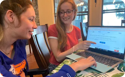 Two women looking at a laptop