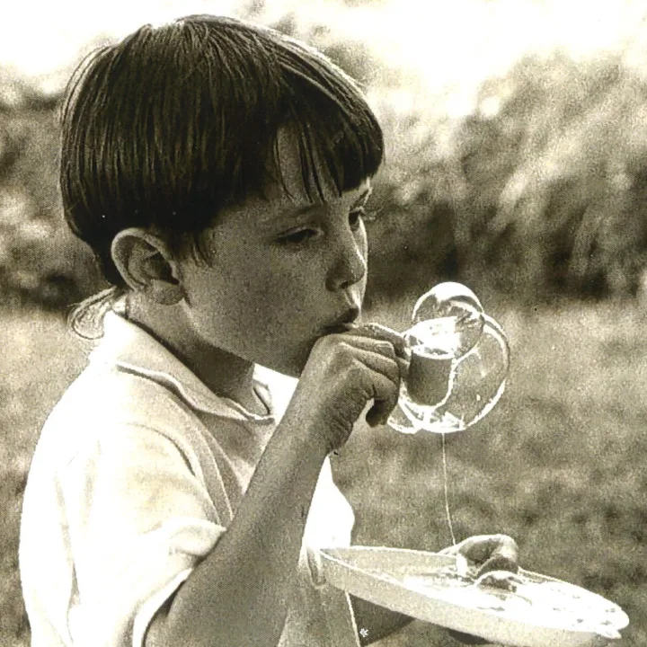 Young boy blowing bubbles