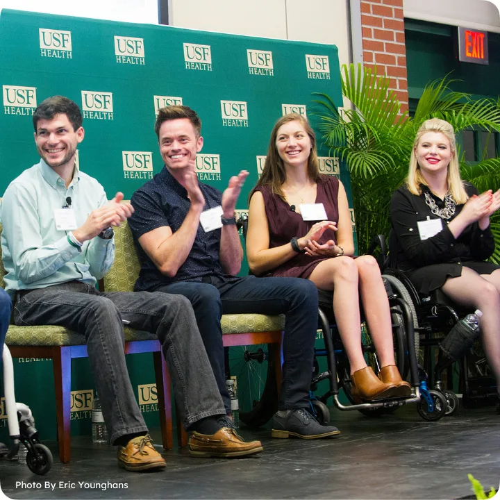 Two men and two women sat on chairs at an event