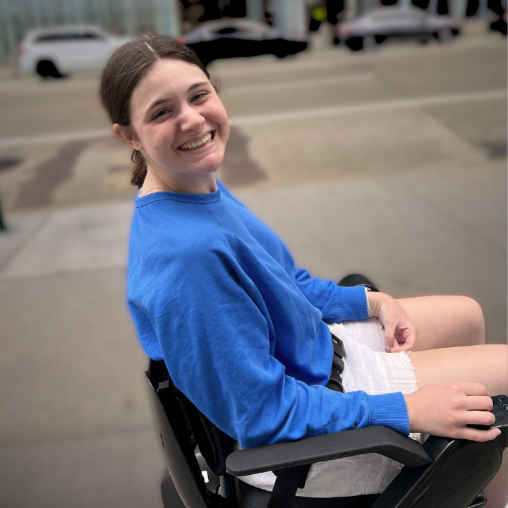 young female in wheelchair on street