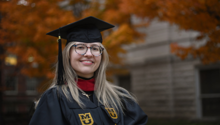 Photo of Shelby Wright in graduation cap and gown.